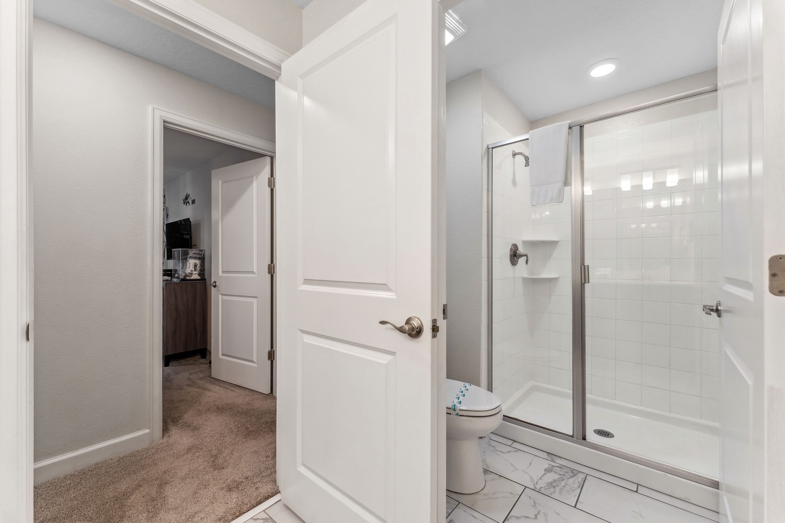 Bright and refreshing second-floor shared bathroom with walk-in shower