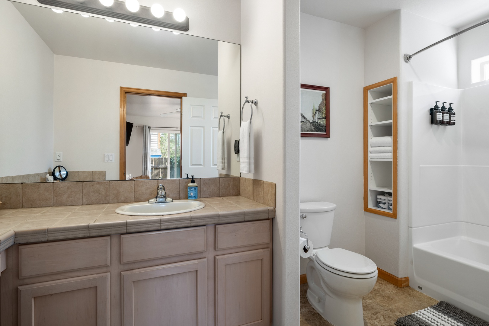 The king en suite includes an oversized single vanity & shower/tub combo