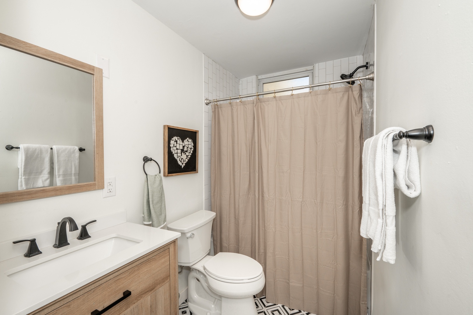 Apt 2 – The full bathroom includes a chic single vanity & shower/tub combo