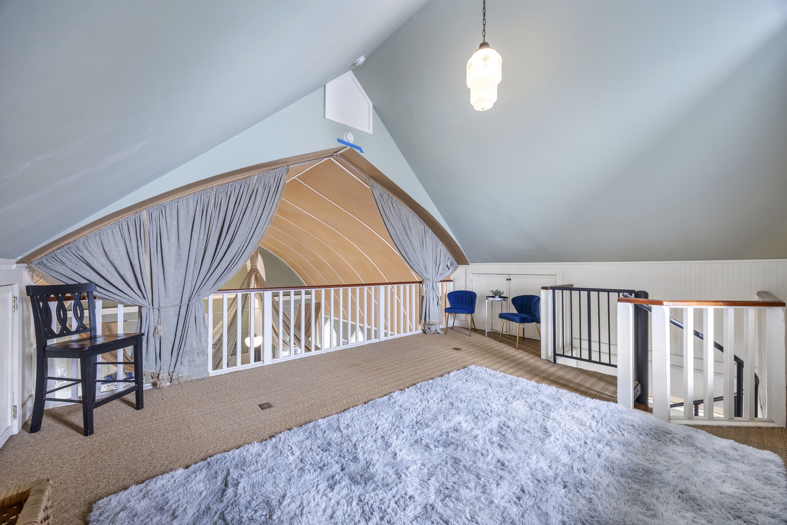 Recharge in the loft sleeping area, boasting a plush queen-sized bed