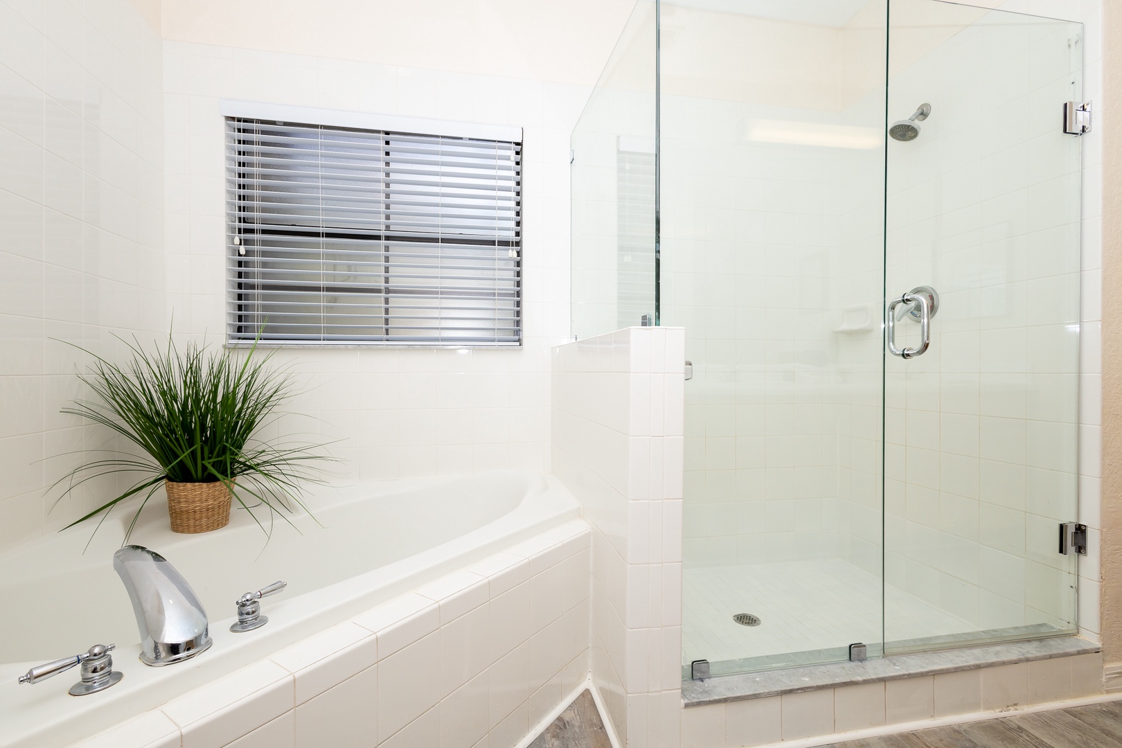The primary ensuite showcases a double vanity, glass shower & soaking tub