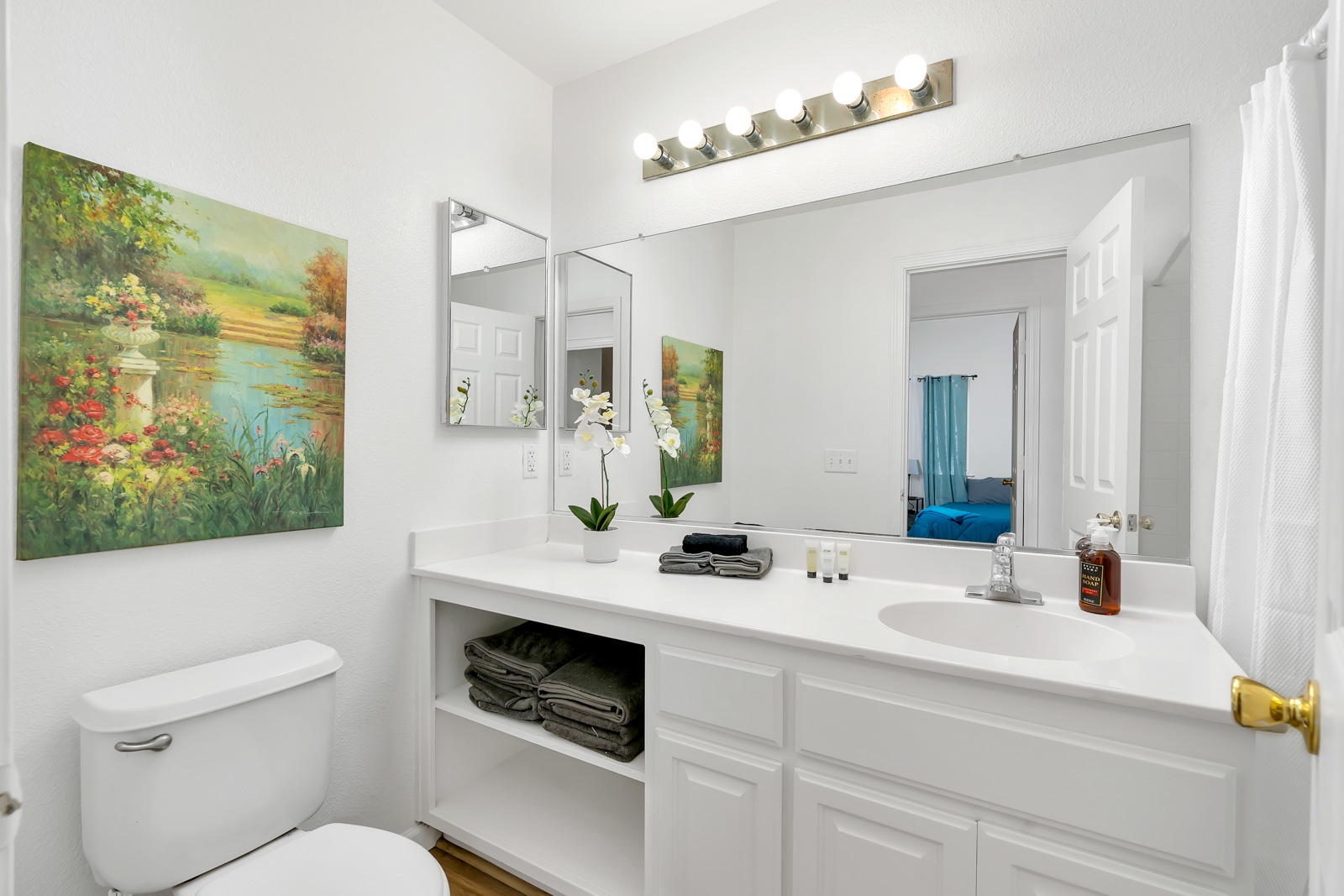 The shared full bathroom offers an oversized vanity & shower/tub combo