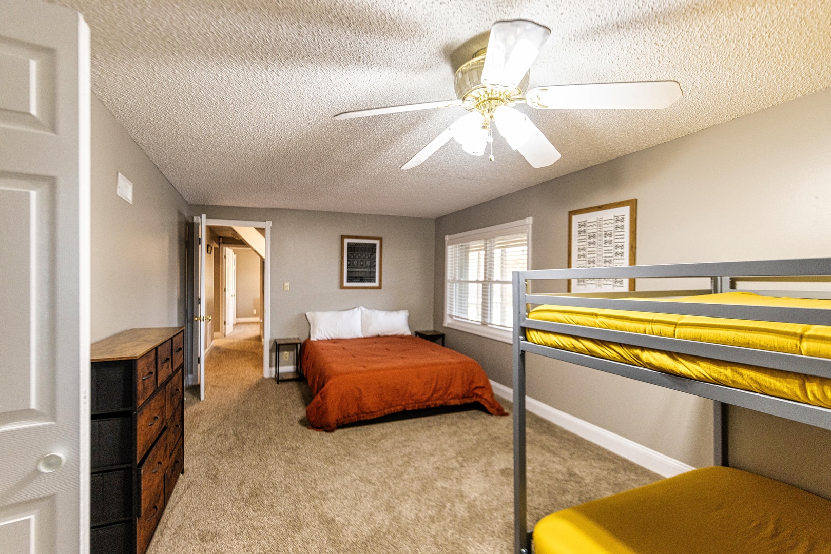 The 2nd lower-level bedroom offers a queen bed & queen-over-queen bunks