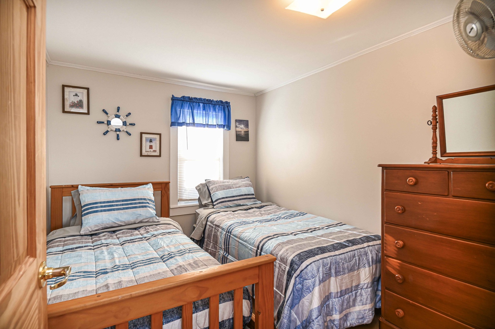 A pair of twin beds & large dresser awaits in the second bedroom