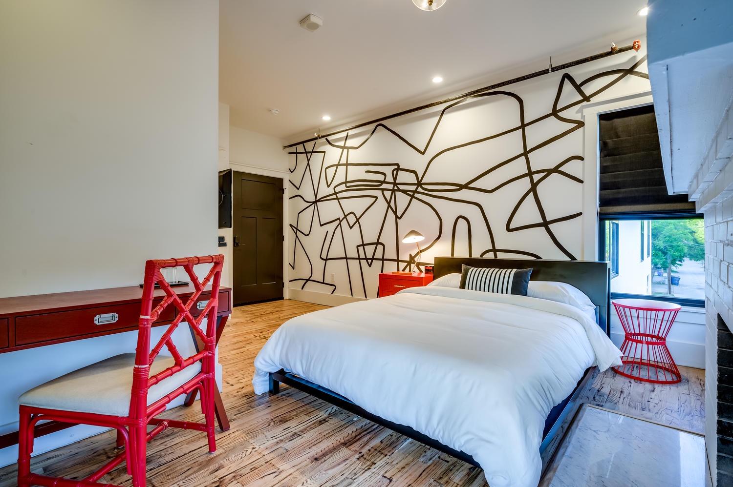 Suite 201 – The 2nd Floor Red, White & Black Suite boasts a Casper Queen Bed, Smart TV, and En Suite Bathroom