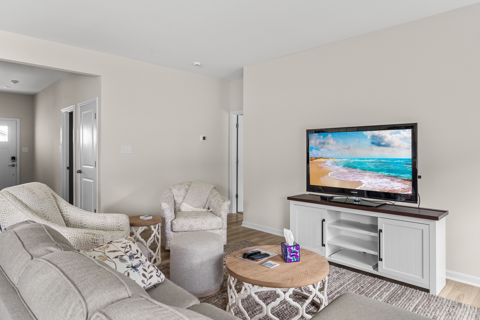 Bright living room with cozy seating, and Smart TV