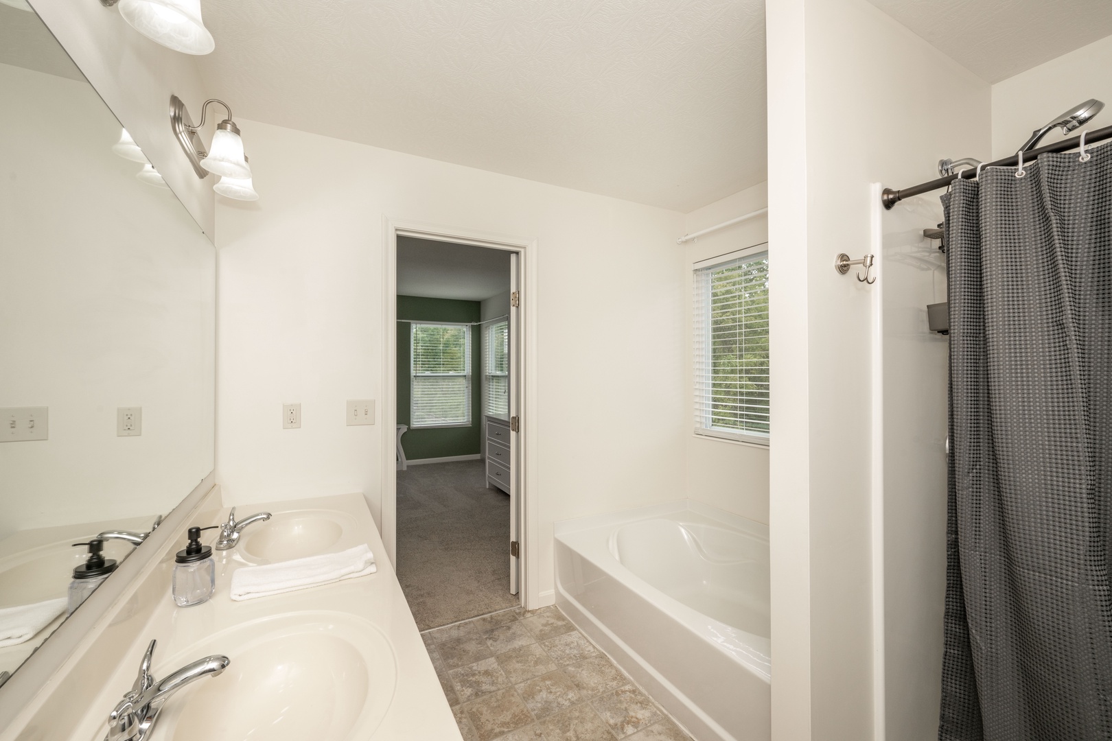 A double vanity, shower, & soaking tub is available in the king ensuite