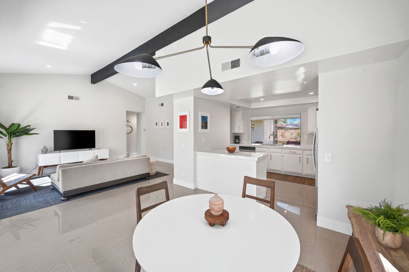 The dining area flows smoothly into the streamlined kitchen