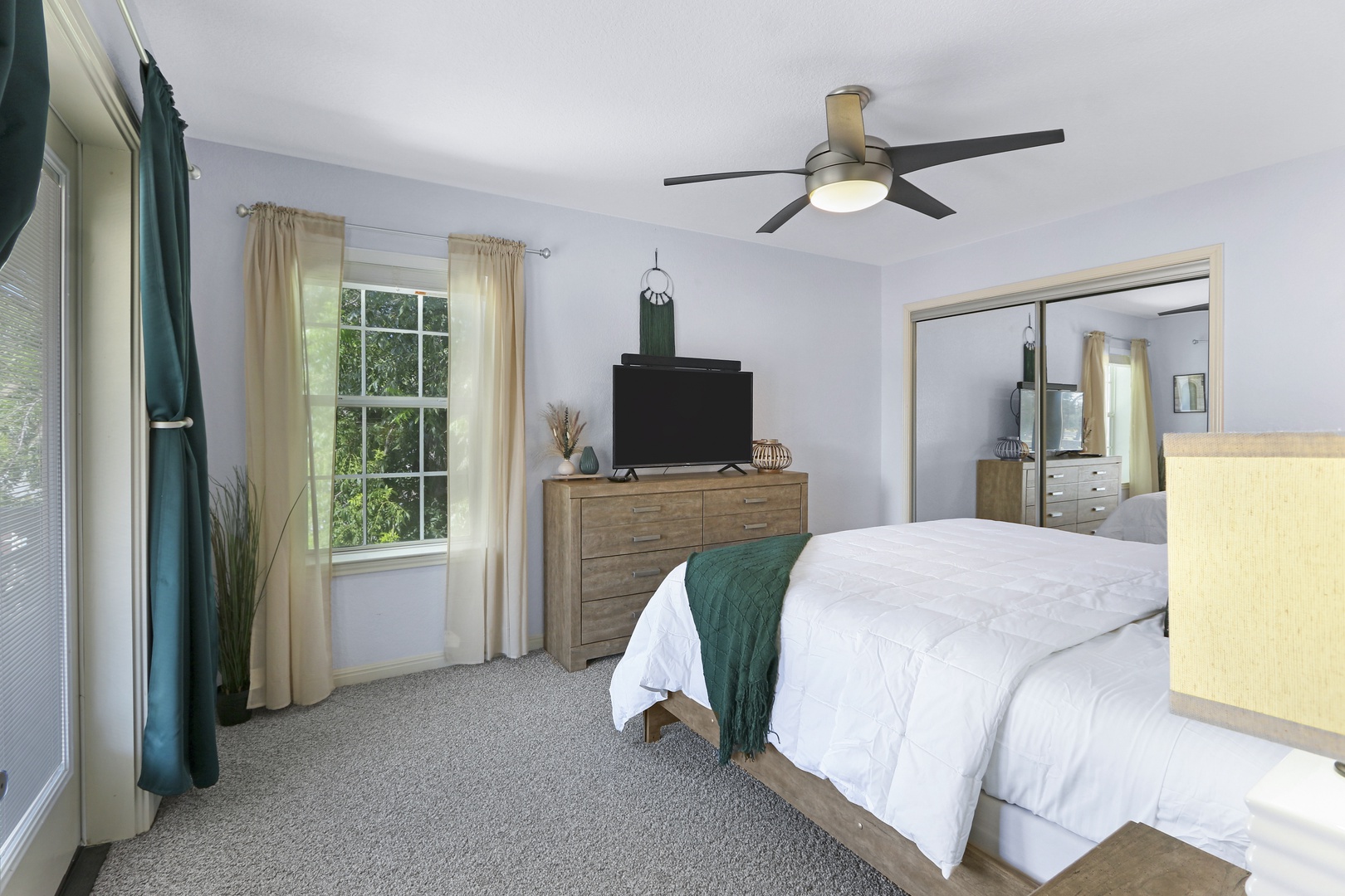 The 2nd floor king bedroom offers a Smart TV, ceiling fan, & deck access