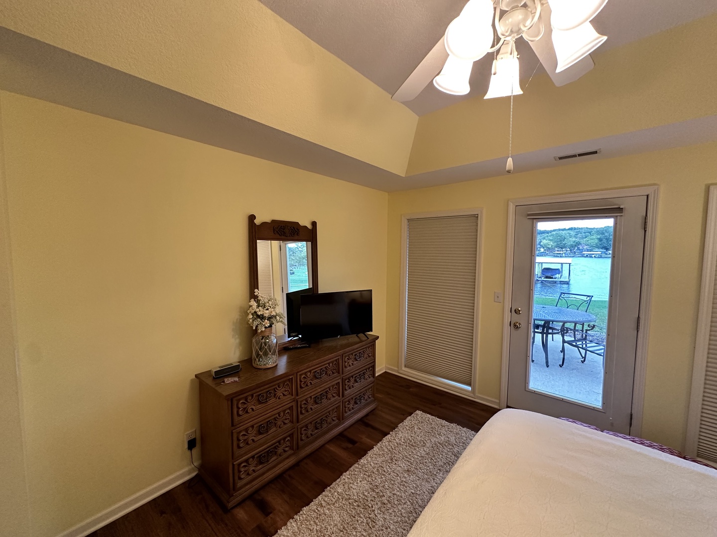 Bedroom 1 with king bed, patio access, Smart TV, and ensuite