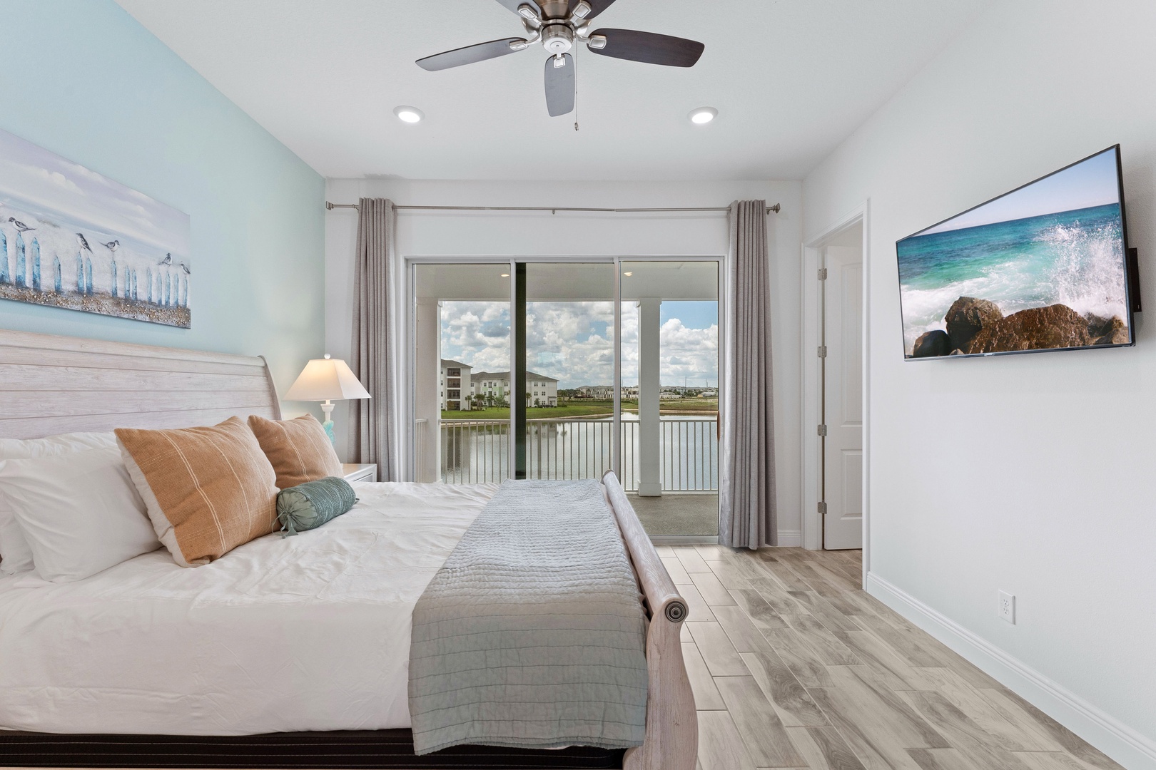 Coastal charm: King bed, smart TV, and balcony with water view