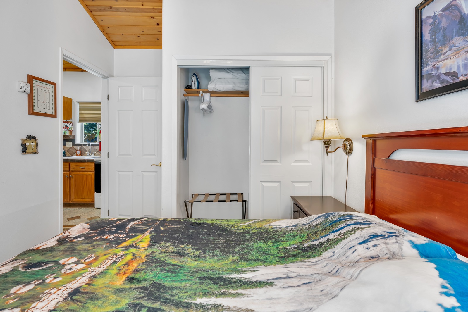 The private bedroom offers soaring ceilings & a regal queen-sized bed