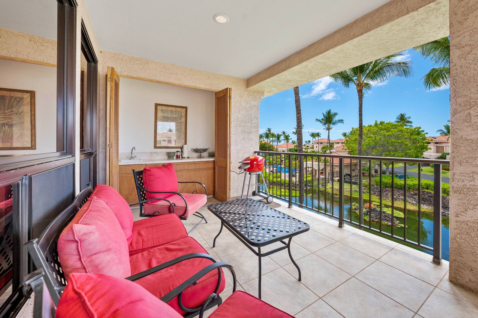 Lanai with sink, lounge chairs, electric grill, and resort view
