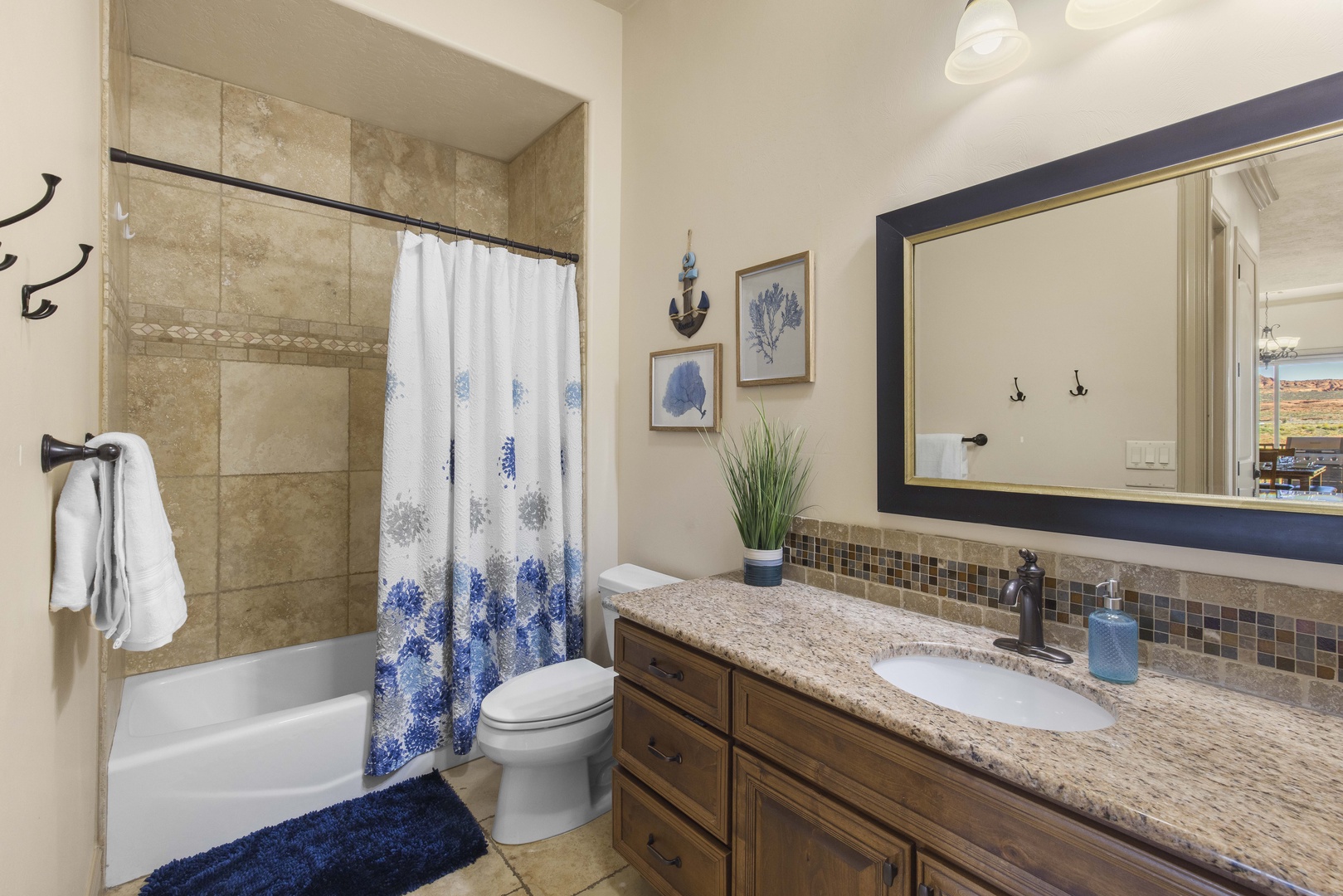 This full bathroom offers an oversized single vanity & shower/tub combo