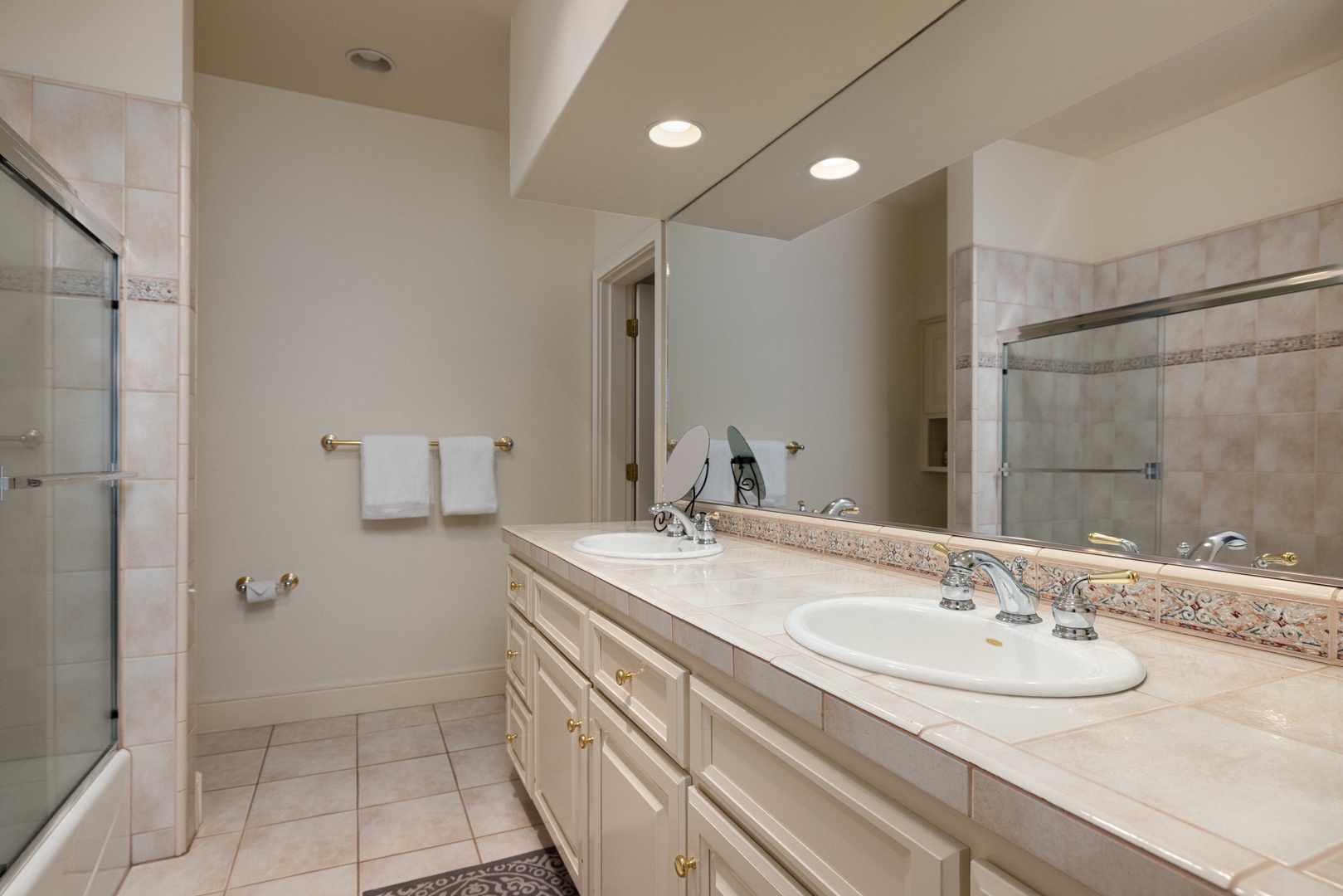 The 1st-floor ensuite bath features a double vanity & shower/tub combo