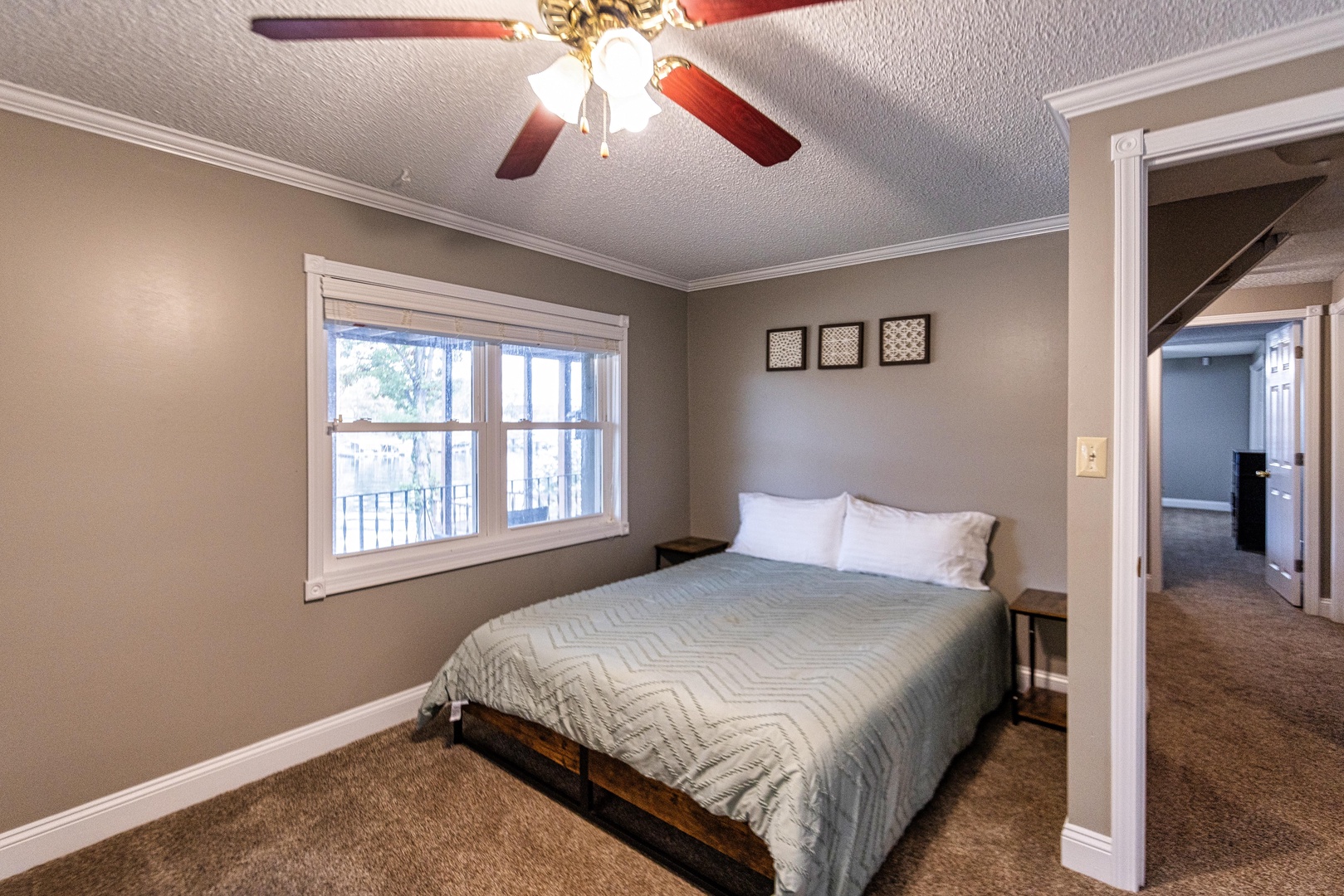 The 1st of 3 lower-level bedrooms offers a queen bed & loads of storage space