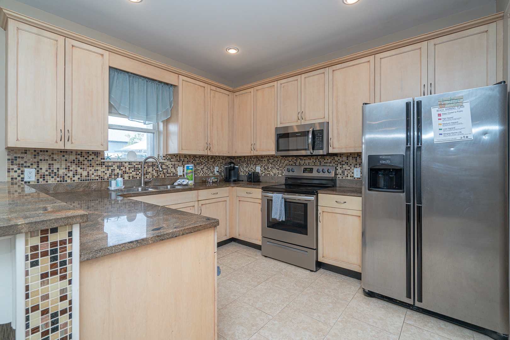 The sleek, updated kitchen offers ample space & all the comforts of home