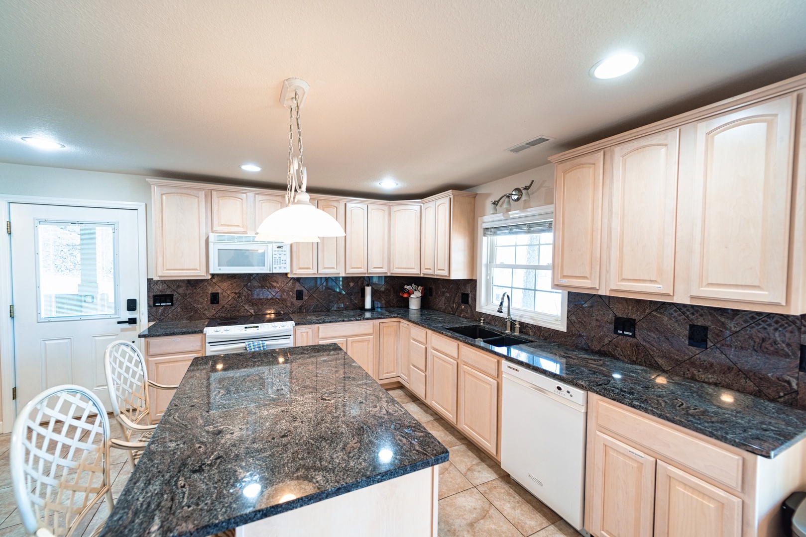 Downstairs, the open kitchen offers ample space & all the comforts of home