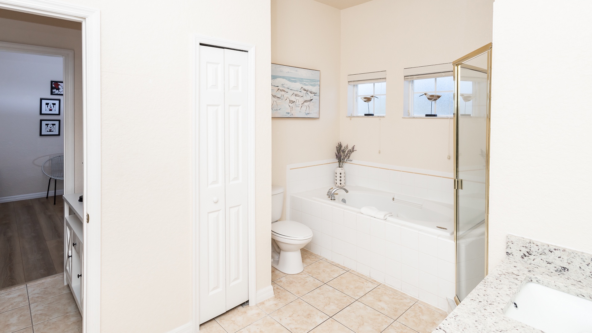 A double vanity, glass shower, & soaking tub await in the second full bath