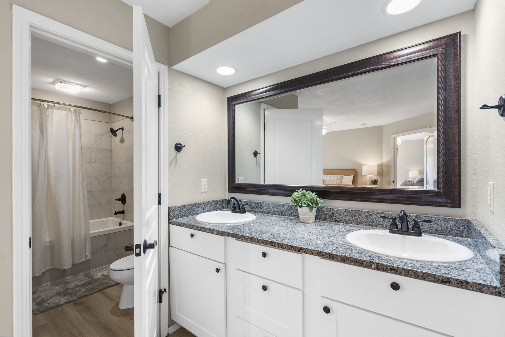 The primary king en suite includes a double vanity & shower/tub combo