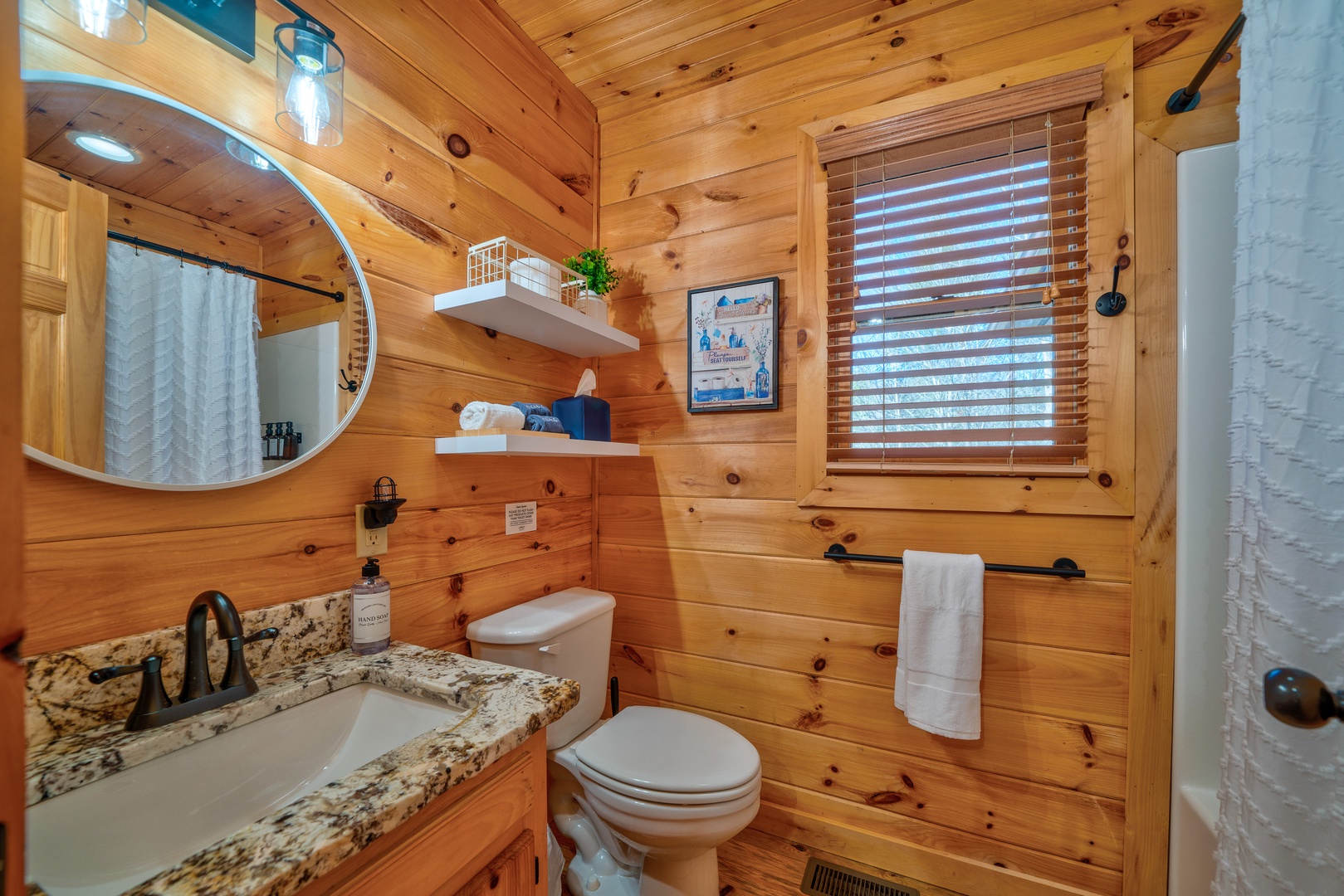 Shared full bathroom with stand up shower off of the laundry area