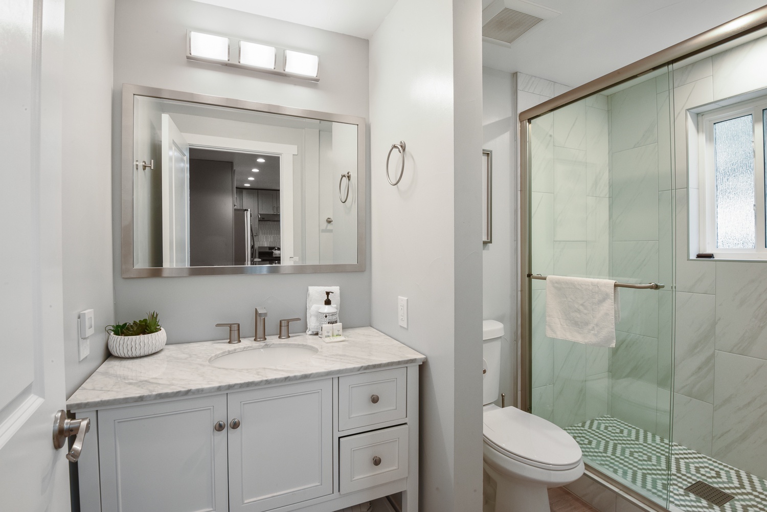 The 2nd level offers a convenient full bathroom with a glass-enclosed shower