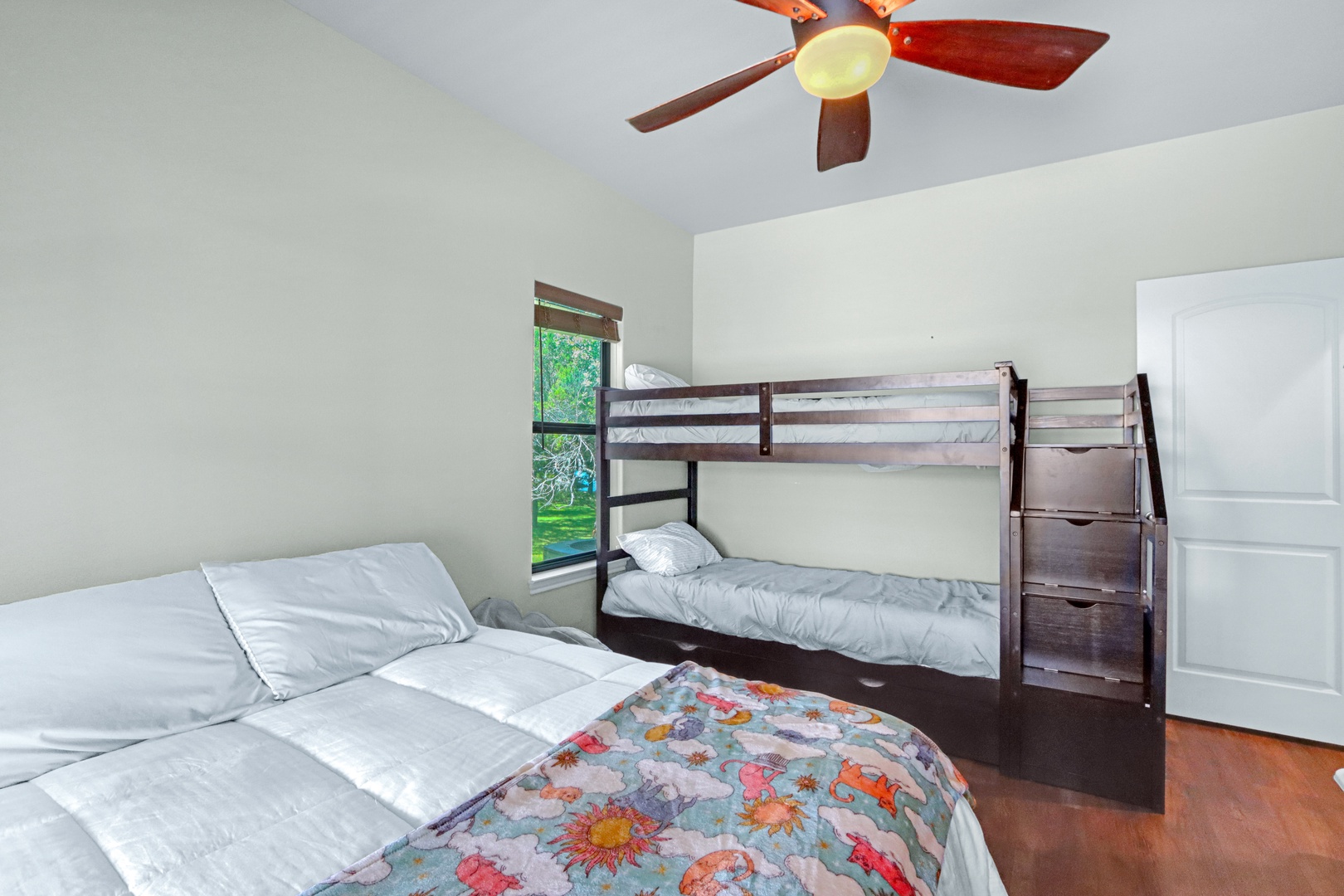 The 1st bedroom, with smart TV, queen bed, & twin-over-full bunks with trundle