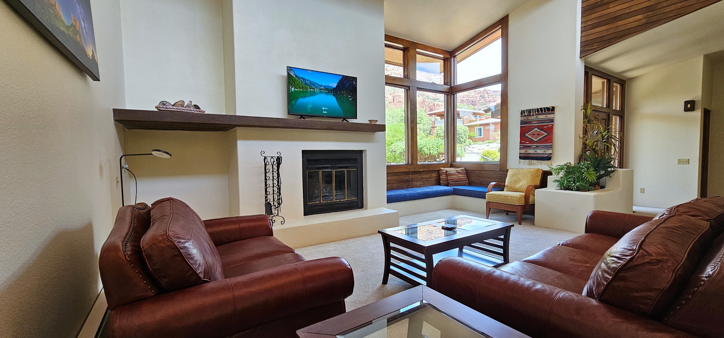 Living room with fireplace, leather seating, and Smart TV