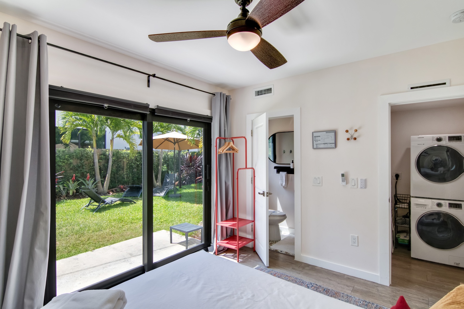 Main House: Bedroom 4 with queen bed, Smart TV, patio access, and ensuite