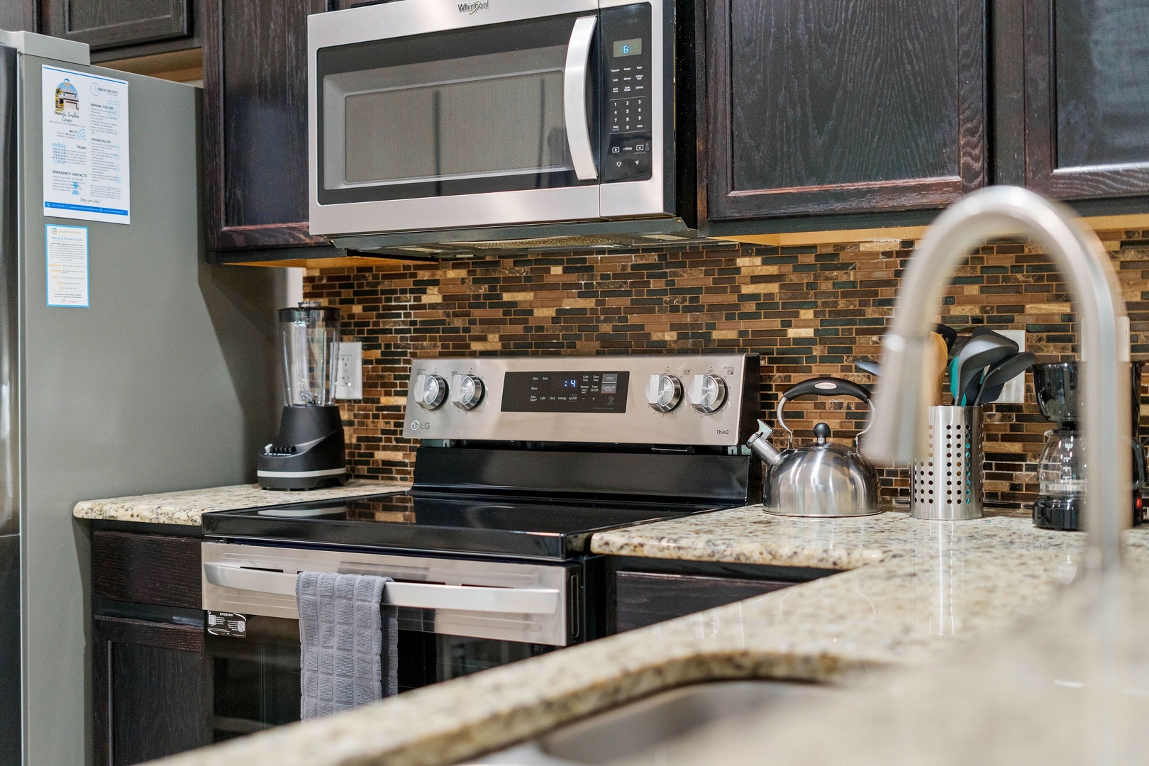 Modern kitchen equipped with stainless steel appliances and granite countertops