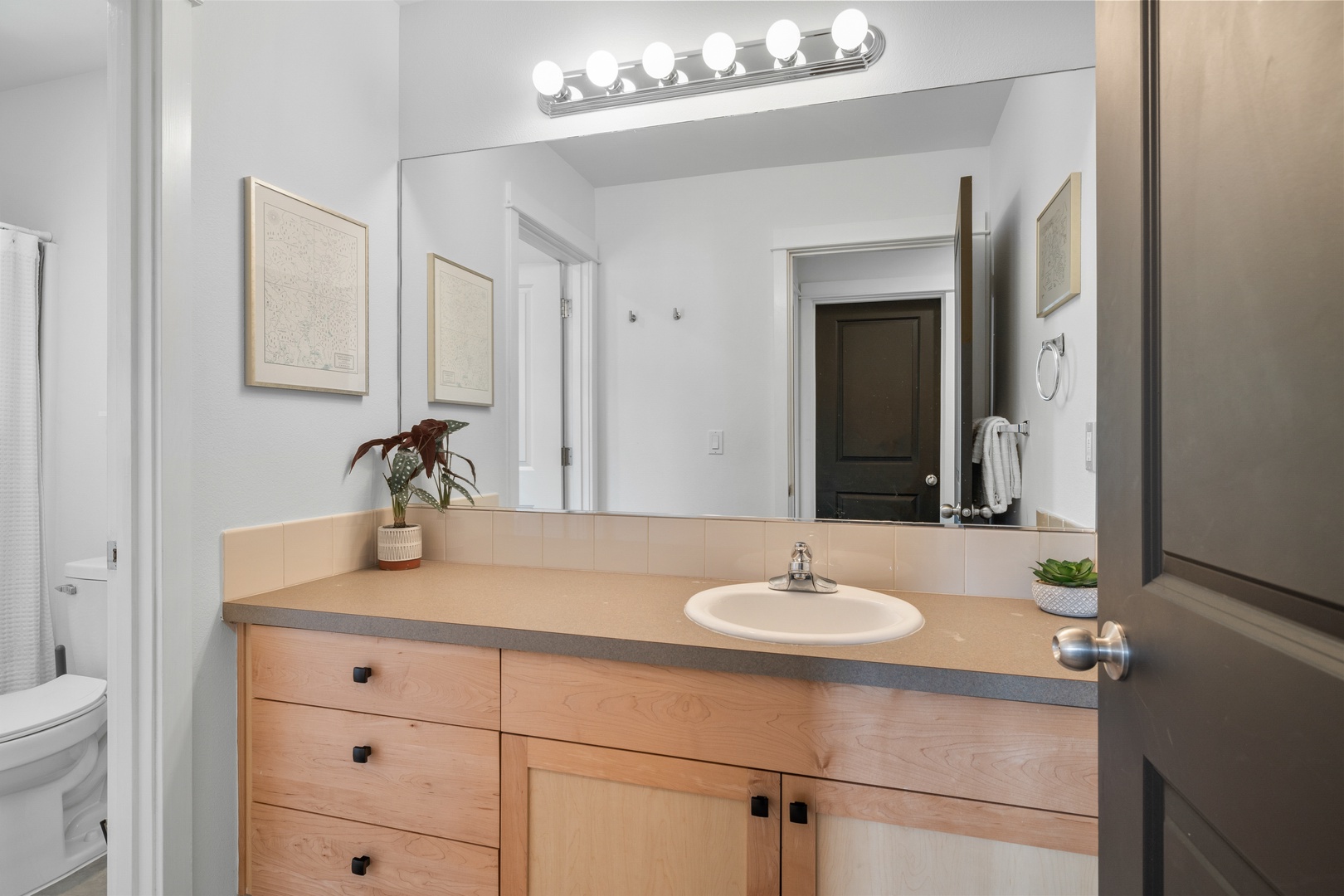 The 2nd floor hall bath offers a large vanity & shower/tub combo