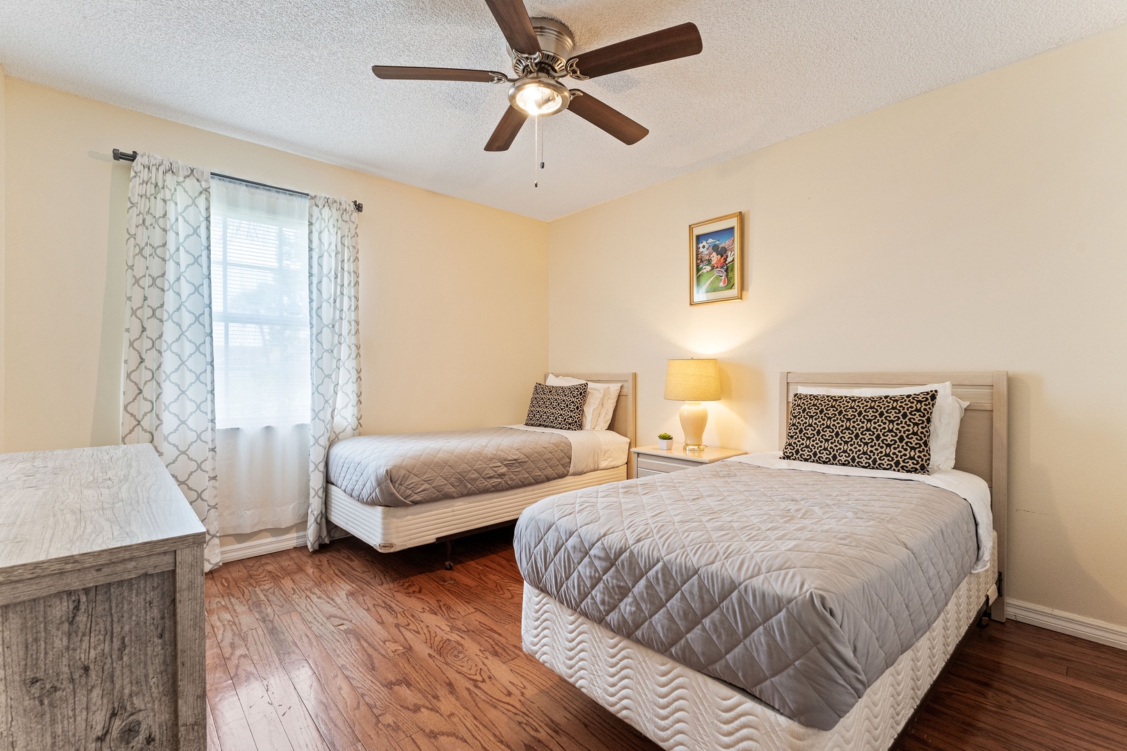 A pair of cozy twin beds awaits in the tranquil third bedroom