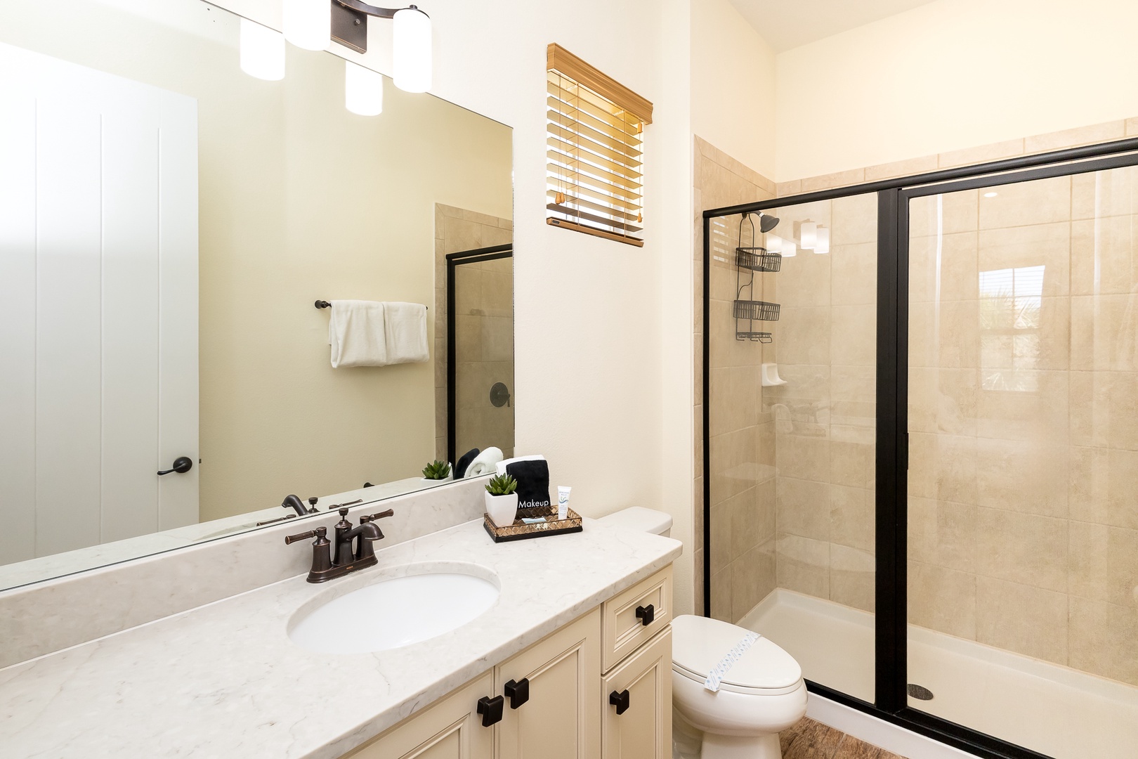 This 2nd-floor ensuite features a large single vanity & glass shower