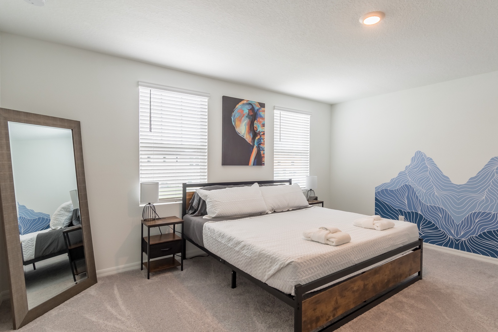 The primary master suite boasts a king bed, private ensuite, & Smart TV