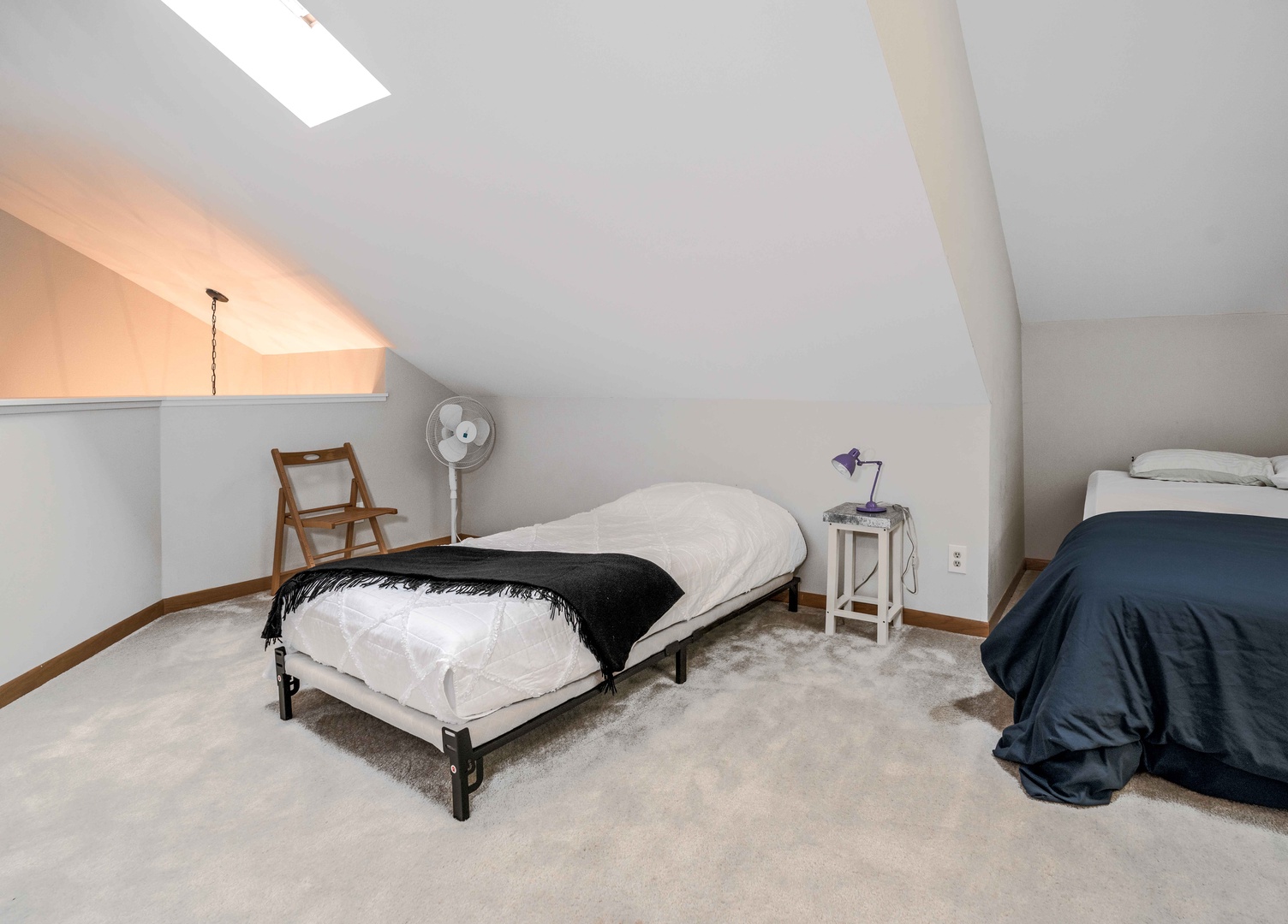 The loft contains a twin bed, queen bed & shared full bathroom