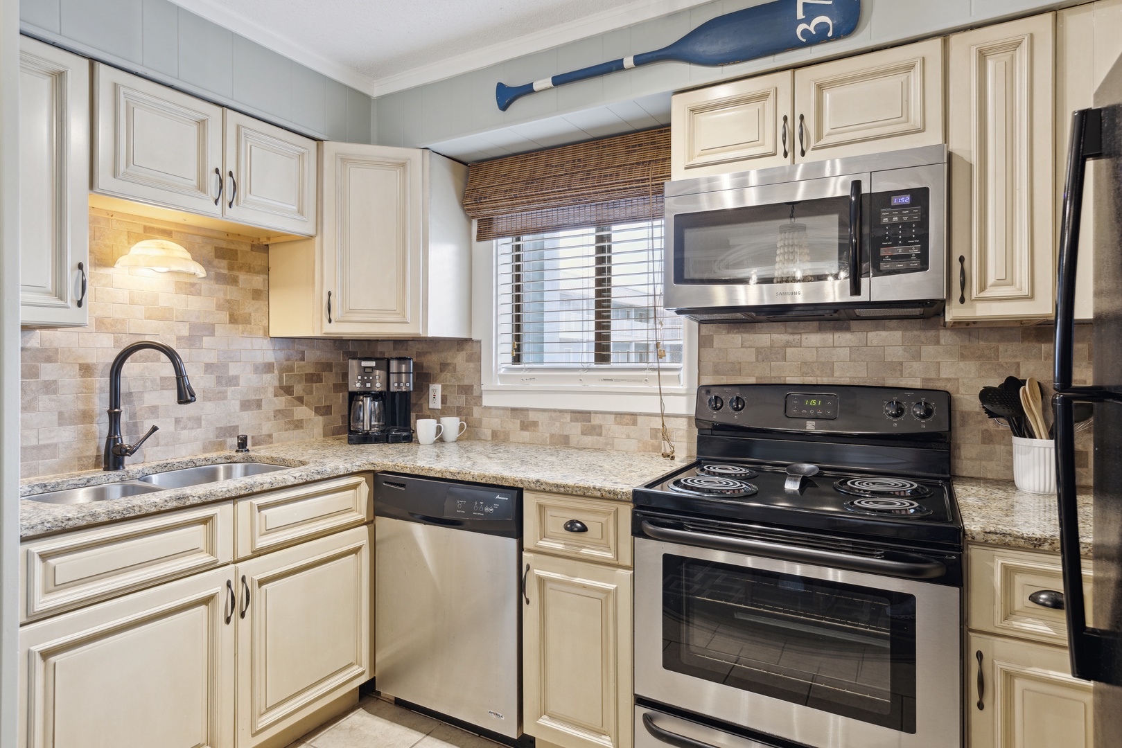 The elegant kitchen offers ample space & all the comforts of home