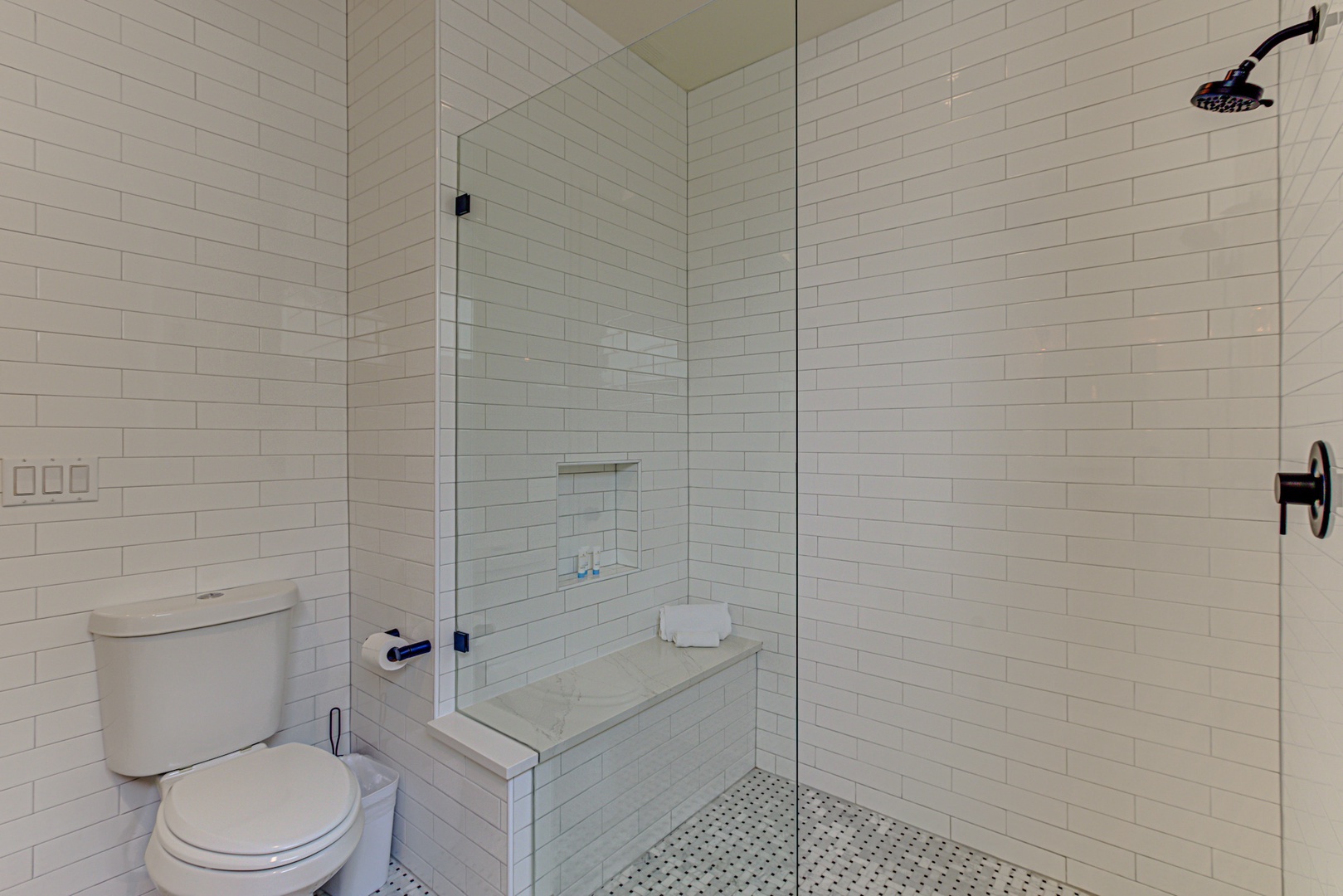 A full bath with single vanity & glass shower is available off the loft