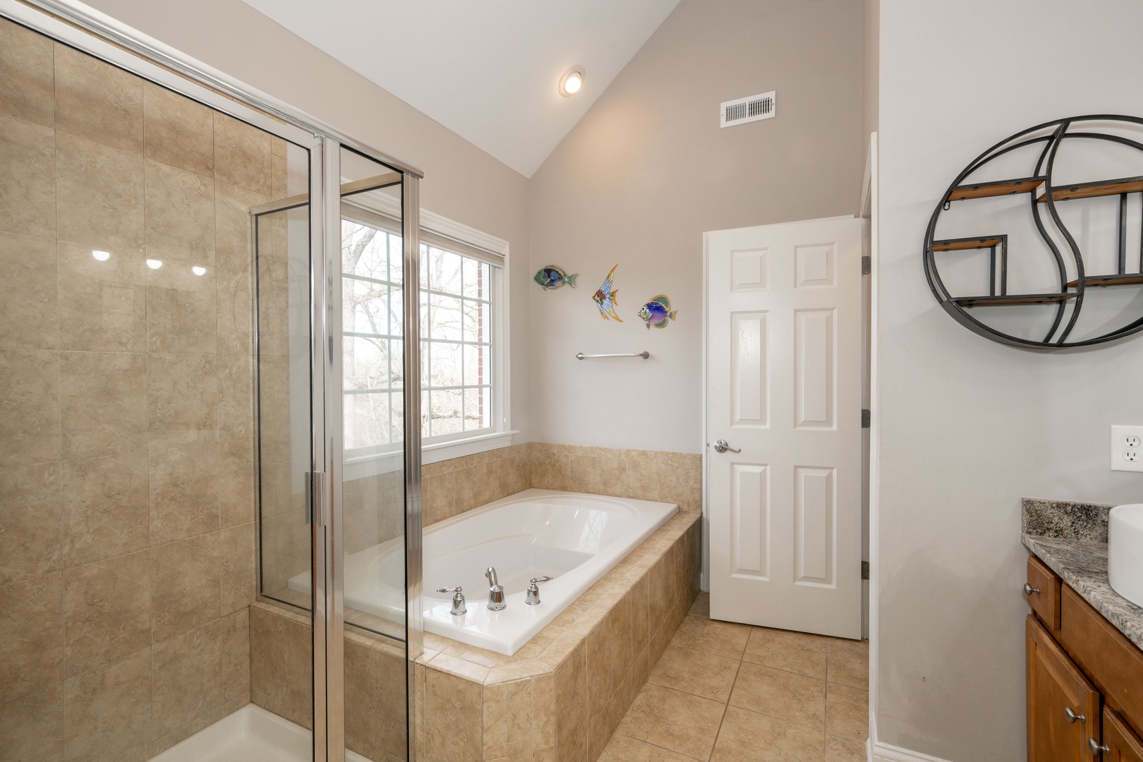 En-suite bathroom with dual sinks, and separate shower & tub