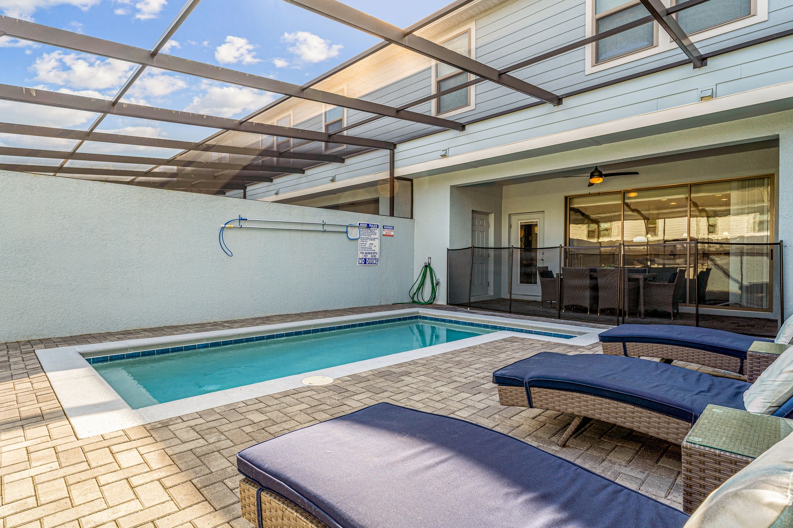 Poolside retreat under the lanai, complete with inviting lounge chairs