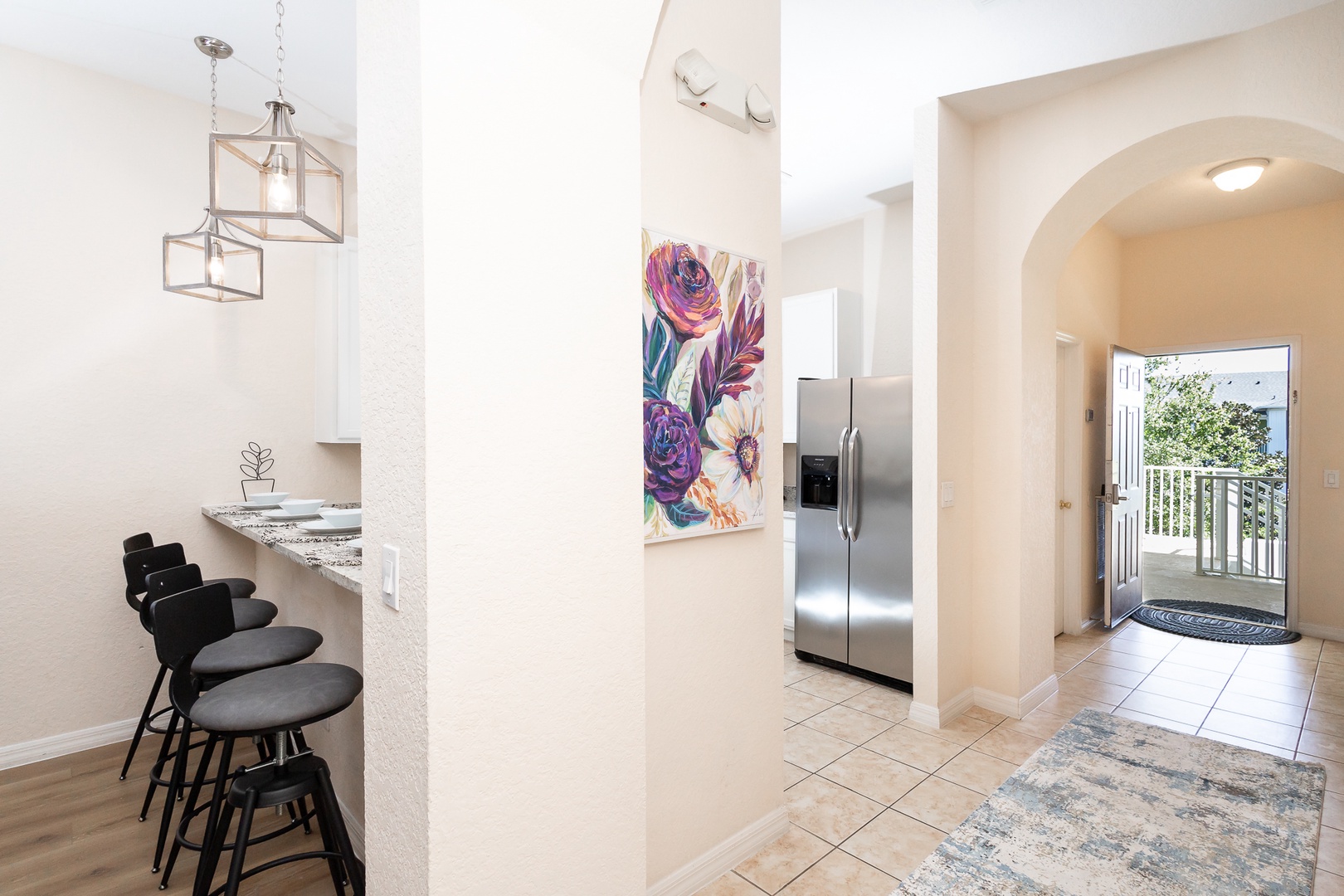 The breezy, open kitchen offers ample space & all the comforts of home