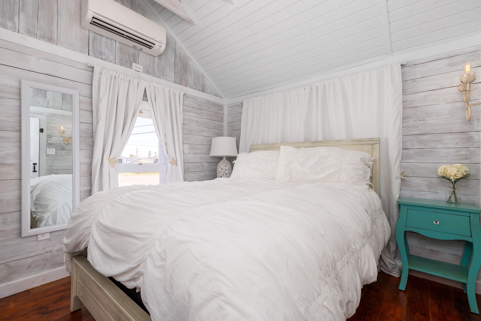 The cozy bedroom offers a plush queen bed and private en suite bathroom