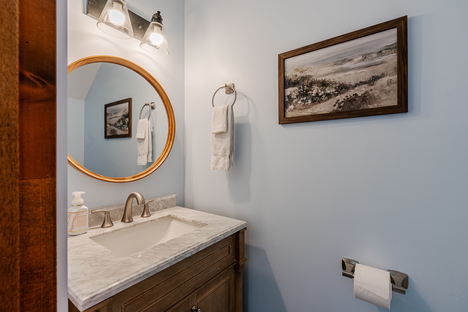 This shared half bathroom contains a single vanity