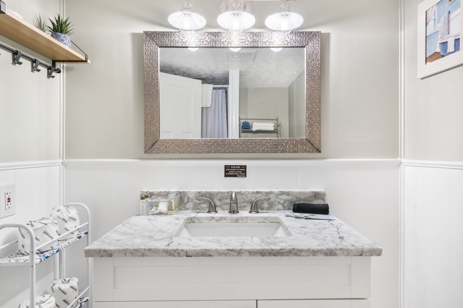 The lower-level full bathroom includes a single vanity & walk-in shower