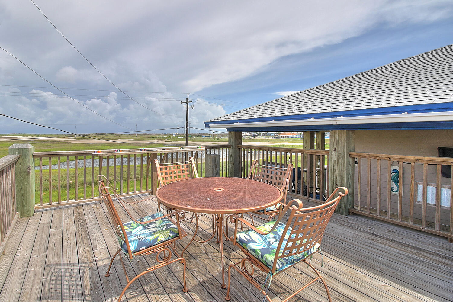 Upper open deck with outdoor table and chairs