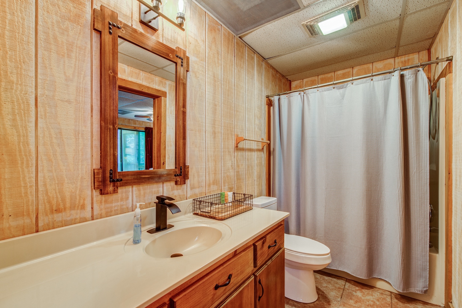 The lower-level en suite offers an oversized vanity & shower/tub combo