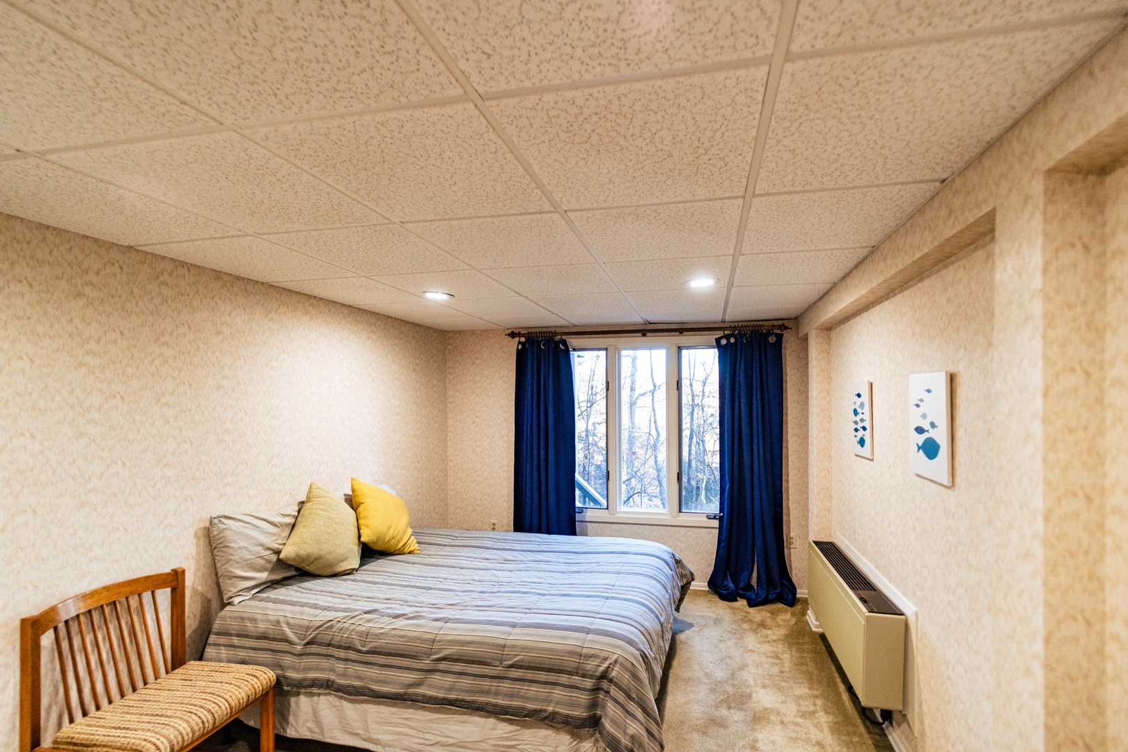 The lower-level bonus room boasts a queen bed, TV for gaming, & seating area