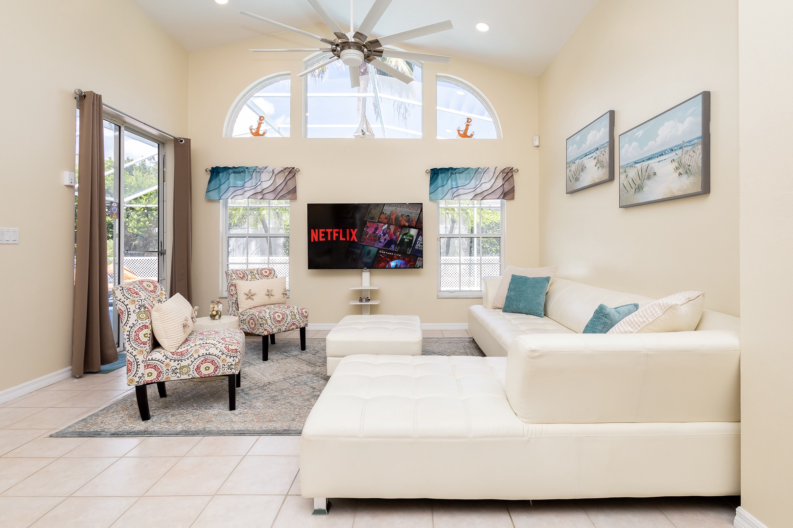 Cozy and spacious living area with, ceiling fan & smart TV