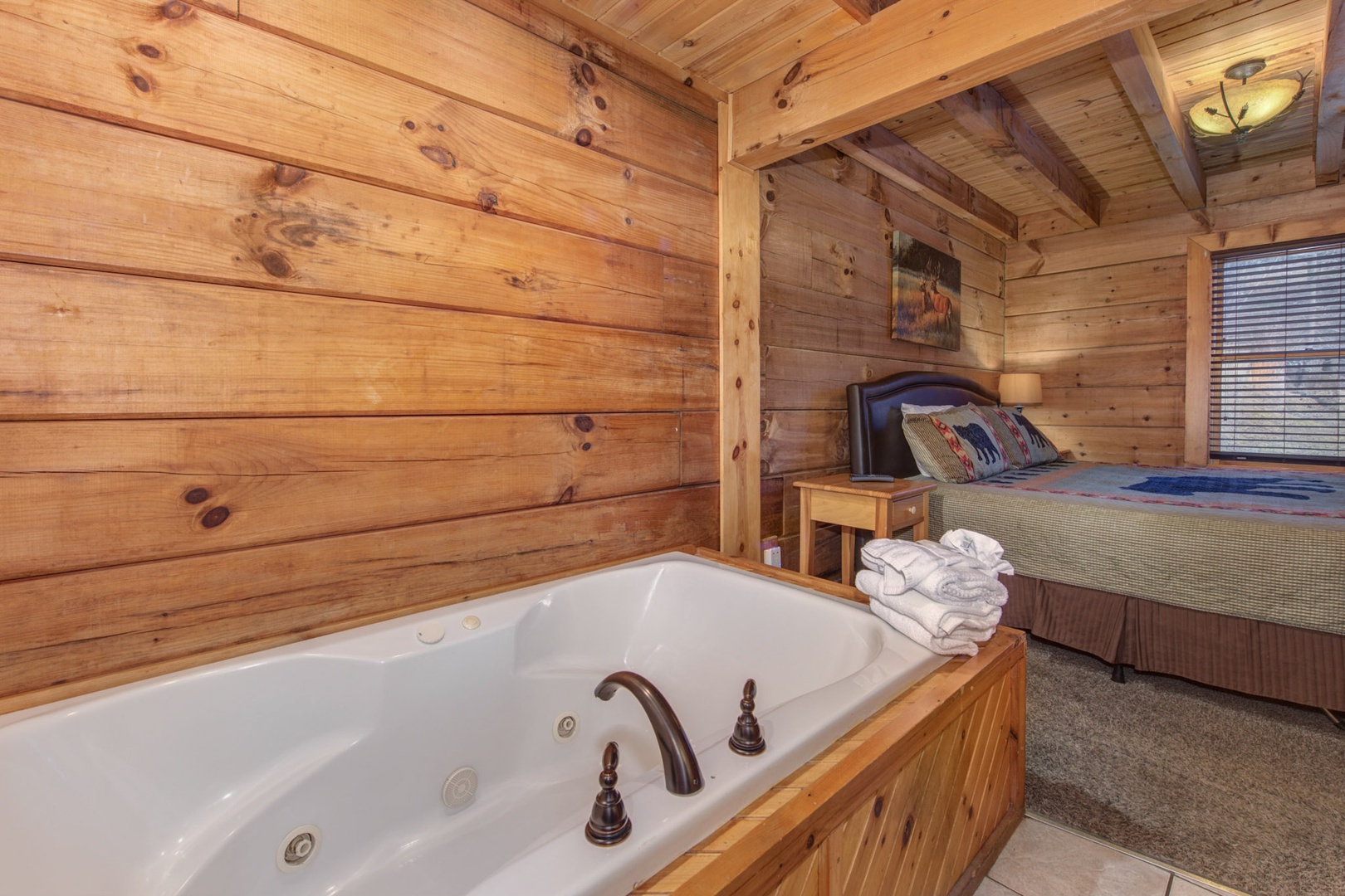 The primary king suite boasts an ensuite with luxurious Jacuzzi tub & TV