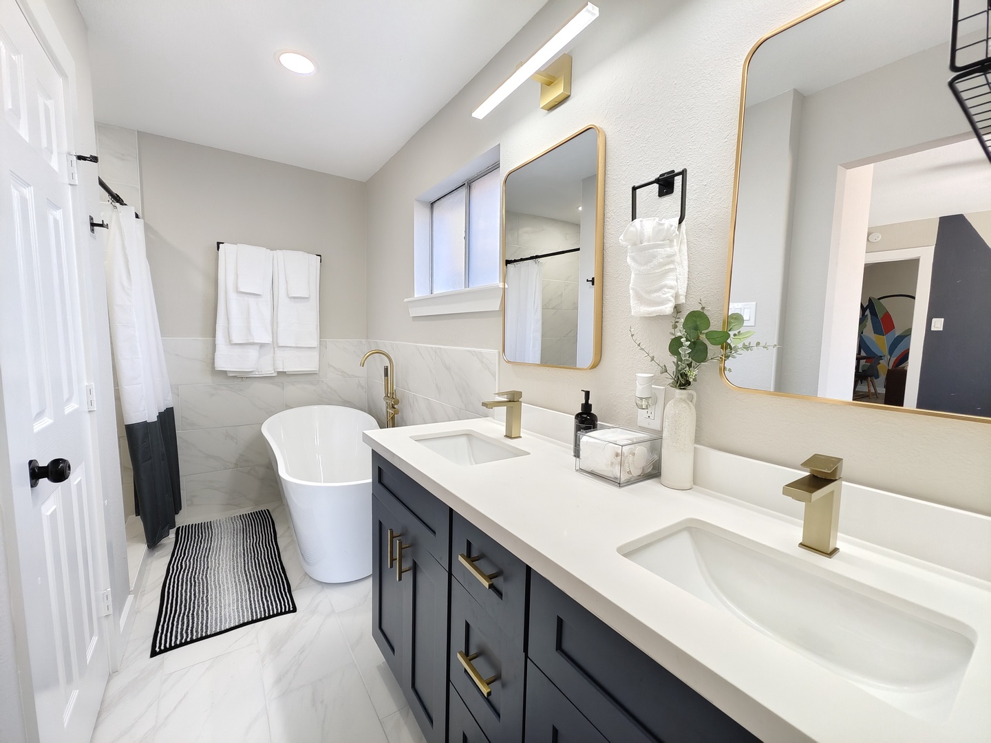 This ensuite features a dual vanity, shower, & luxurious soaking tub