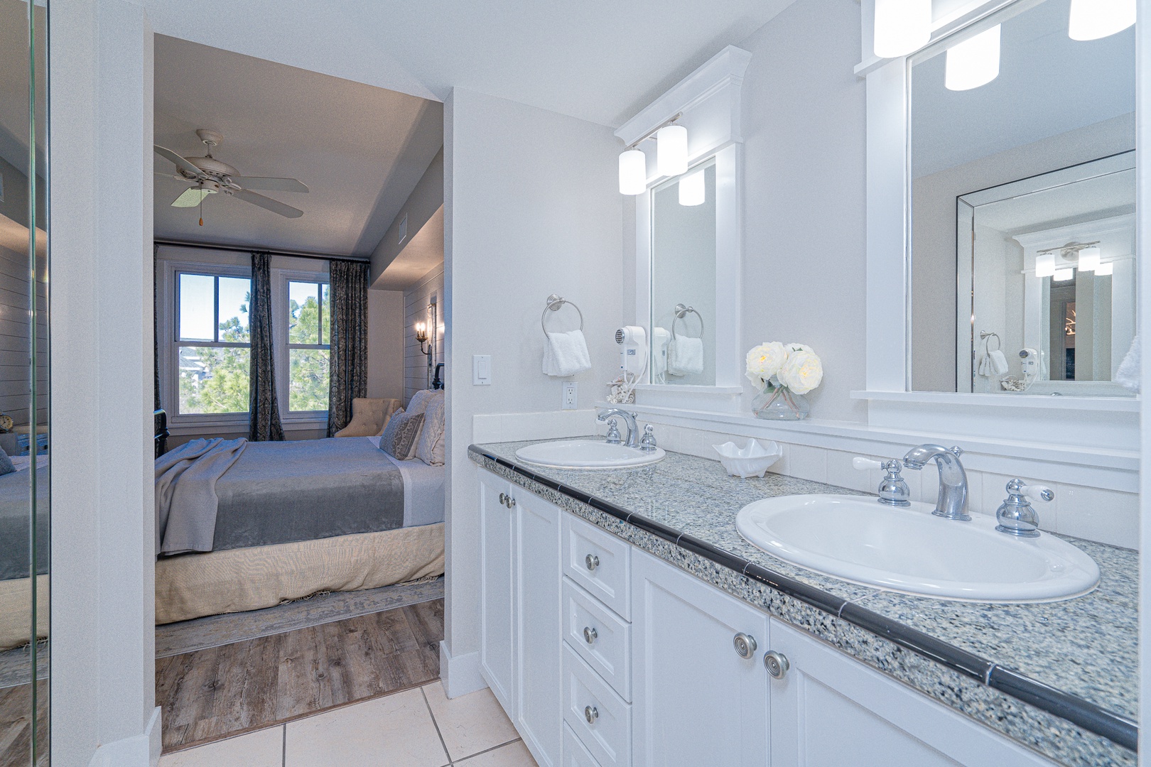 A double vanity & shower/tub combo await in the polished master ensuite